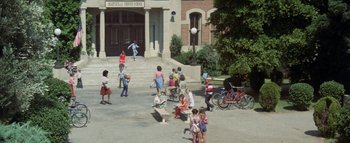 Movie still from “The Swarm” (1978), directed by Irwin Allen – A group of children are playing in the street; Extreme Wide shot, High angle