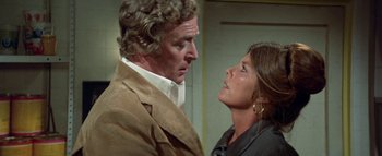 Movie still from “The Swarm” (1978), directed by Irwin Allen – A man and a woman face to face in front of a wall; Close Up shot, Over the shoulder angle