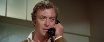Movie still from “The Swarm” (1978), directed by Irwin Allen – A person talking on a phone; Close Up shot, Over the shoulder angle