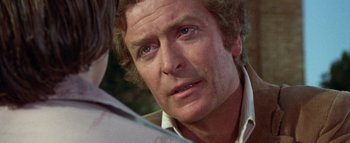 Movie still from “The Swarm” (1978), directed by Irwin Allen – An older man is looking at the camera; Close Up shot, Over the shoulder angle