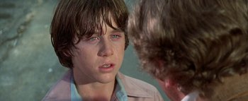 Movie still from “The Swarm” (1978), directed by Irwin Allen – A young boy is crying in front of a mirror; Close Up shot, Over the shoulder angle