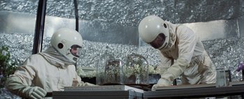 Movie still from “The Swarm” (1978), directed by Irwin Allen – Two men in spacesuits working on a project; Medium shot, Low angle