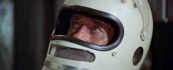 Movie still from “The Swarm” (1978), directed by Irwin Allen – A person wearing a helmet; Close Up shot, High angle