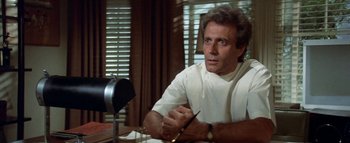 Movie still from “The Swarm” (1978), directed by Irwin Allen – A man sitting in front of a mirror in a room; Close Up shot, Low angle