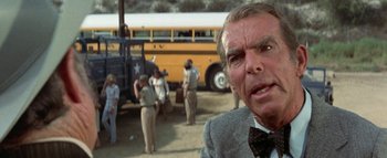 Movie still from “The Swarm” (1978), directed by Irwin Allen – An older man in front of an old school bus; Close Up shot, Over the shoulder angle