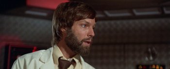 Movie still from “The Swarm” (1978), directed by Irwin Allen – A person wearing a suit and tie; Close Up shot, Low angle