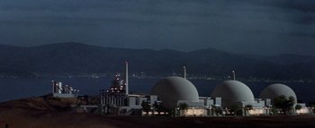 Movie still from “The Swarm” (1978), directed by Irwin Allen – A large building that has a dome on top of it; Extreme Wide shot, Low angle