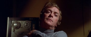 Movie still from “The Swarm” (1978), directed by Irwin Allen – A person wearing a sweater; Close Up shot, Low angle