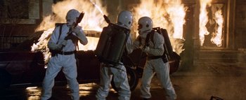 Movie still from “The Swarm” (1978), directed by Irwin Allen – A group of men in white suits and helmets; Medium shot, High angle