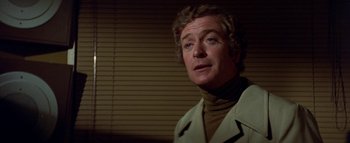 Movie still from “The Swarm” (1978), directed by Irwin Allen – A person wearing a jacket; Close Up shot, Over the shoulder angle