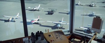 Movie still from “The Swarm” (1978), directed by Irwin Allen – A view of a bunch of planes on the tarmac; Wide shot, High angle