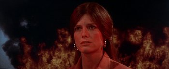 Movie still from “The Swarm” (1978), directed by Irwin Allen – A person with a fire background; Close Up shot, Low angle