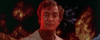 Movie still from “The Swarm” (1978), directed by Irwin Allen – A person wearing a suit; Close Up shot, Low angle