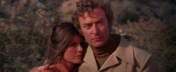 Movie still from “The Swarm” (1978), directed by Irwin Allen – A man and a woman standing next to each other; Close Up shot, Low angle