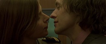 Movie still from “The Truth About Charlie” (2002), directed by Jonathan Demme – A man and a woman are kissing each other; Close Up shot, Low angle