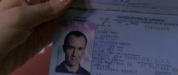 Movie still from “The Truth About Charlie” (2002), directed by Jonathan Demme – A passport with a picture of a man in it; Extreme Close Up shot, High angle