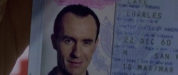 Movie still from “The Truth About Charlie” (2002), directed by Jonathan Demme – A man's face on top of a passport; Extreme Close Up shot, Overhead angle