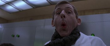 Movie still from “The Truth About Charlie” (2002), directed by Jonathan Demme – A man wearing a scarf and a fake face; Close Up shot, Low angle