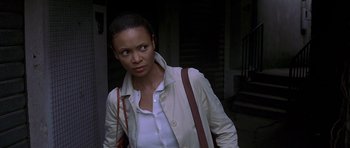 Movie still from “The Truth About Charlie” (2002), directed by Jonathan Demme – A woman in a white shirt and a white jacket; Close Up shot, High angle