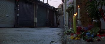 Movie still from “The Truth About Charlie” (2002), directed by Jonathan Demme – A person walking down a street near a building; Extreme Wide shot, High angle