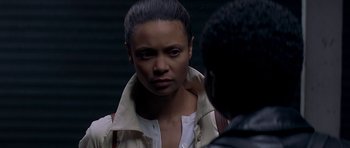 Movie still from “The Truth About Charlie” (2002), directed by Jonathan Demme – A woman in a white jacket is looking at a man; Close Up shot, Over the shoulder angle