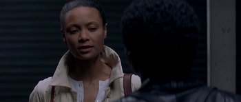 Movie still from “The Truth About Charlie” (2002), directed by Jonathan Demme – A woman standing next to a man on a sidewalk; Close Up shot, Over the shoulder angle