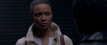 Movie still from “The Truth About Charlie” (2002), directed by Jonathan Demme – A woman in a white shirt is looking at the camera; Close Up shot, Over the shoulder angle