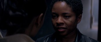 Movie still from “The Truth About Charlie” (2002), directed by Jonathan Demme – A woman is looking at a man in a dark room; Close Up shot, Over the shoulder angle