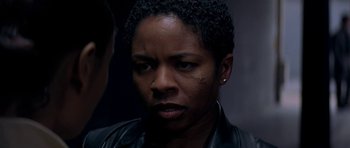 Movie still from “The Truth About Charlie” (2002), directed by Jonathan Demme – A person wearing a leather jacket; Close Up shot, Over the shoulder angle