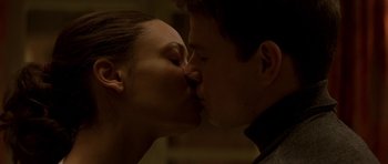 Movie still from “The Truth About Charlie” (2002), directed by Jonathan Demme – A man and a woman kissing each other; Close Up shot, Low angle