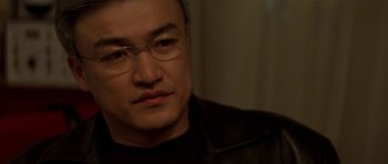 Movie still from “The Truth About Charlie” (2002), directed by Jonathan Demme – A person wearing glasses; Close Up shot, Over the shoulder angle