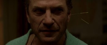 Movie still from “The Truth About Charlie” (2002), directed by Jonathan Demme – A man's face with a towel around his neck; Close Up shot, Low angle