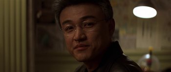 Movie still from “The Truth About Charlie” (2002), directed by Jonathan Demme – A person wearing glasses; Close Up shot, Low angle