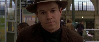 Movie still from “The Truth About Charlie” (2002), directed by Jonathan Demme – A person wearing a hat; Close Up shot, Over the shoulder angle