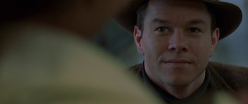 Movie still from “The Truth About Charlie” (2002), directed by Jonathan Demme – A man wearing a cowboy hat; Close Up shot, Over the shoulder angle