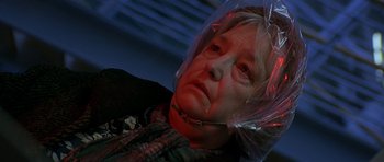 Movie still from “The Truth About Charlie” (2002), directed by Jonathan Demme – An older woman with a plastic bag over her head; Close Up shot, Low angle