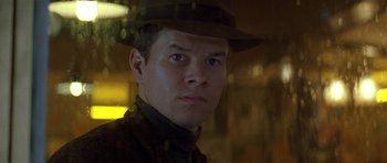 Movie still from “The Truth About Charlie” (2002), directed by Jonathan Demme – A man wearing a hat is looking at the camera; Close Up shot, Low angle