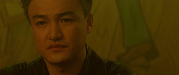 Movie still from “The Truth About Charlie” (2002), directed by Jonathan Demme – A man's face in a dark room; Close Up shot, Low angle