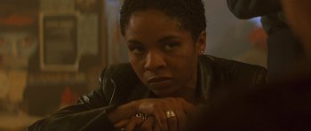 Movie still from “The Truth About Charlie” (2002), directed by Jonathan Demme – A person wearing a leather jacket; Close Up shot, Over the shoulder angle
