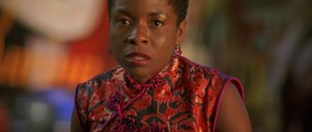 Movie still from “The Truth About Charlie” (2002), directed by Jonathan Demme – A person with short hair wearing a dress; Close Up shot, Low angle