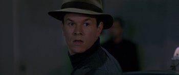 Movie still from “The Truth About Charlie” (2002), directed by Jonathan Demme – A person wearing a hat; Close Up shot, Over the shoulder angle