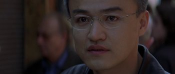 Movie still from “The Truth About Charlie” (2002), directed by Jonathan Demme – A person wearing glasses; Close Up shot, Low angle