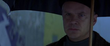 Movie still from “The Truth About Charlie” (2002), directed by Jonathan Demme – A person holding an open umbrella; Close Up shot, Low angle