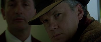 Movie still from “The Truth About Charlie” (2002), directed by Jonathan Demme – A person wearing a hat; Close Up shot, Low angle