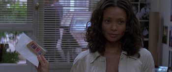 Movie still from “The Truth About Charlie” (2002), directed by Jonathan Demme – A person wearing a white shirt; Close Up shot, Over the shoulder angle