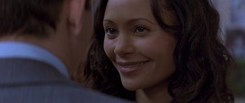 Movie still from “The Truth About Charlie” (2002), directed by Jonathan Demme – A person smiling; Close Up shot, Over the shoulder angle