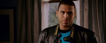 Movie still from “This Christmas” (2007), directed by Preston A. Whitmore II – A young man wearing a black leather jacket and blue shirt; Close Up shot, High angle