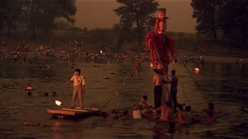 Movie still from “Time of the Gypsies” (1988), directed by Emir Kusturica – A group of people standing in the middle of a body of water; Extreme Wide shot, High angle