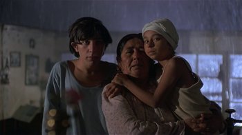 Movie still from “Time of the Gypsies” (1988), directed by Emir Kusturica – A woman and two young girls are standing together; Medium shot, Low angle