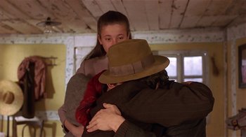 Movie still from “Time of the Gypsies” (1988), directed by Emir Kusturica – A man and a woman hugging in a room; Medium shot, Over the shoulder angle